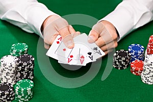 Poker player with cards and chips at casino