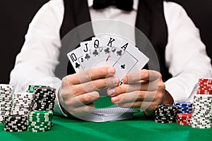 Poker player with cards and chips at casino