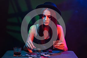 poker player at a casino table with cards and chips