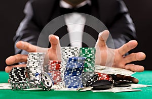 Poker player with chips and money at casino table