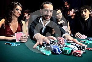 Poker player going all in pushing his chips