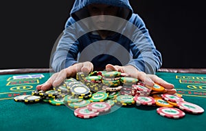 Poker player going all in pushing his chips forward photo