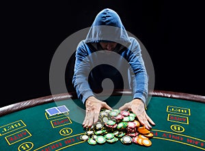 Poker player going all-in pushing his chips forward