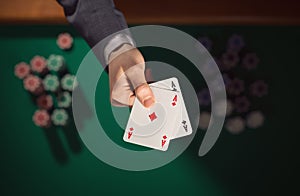 Poker player holding two aces