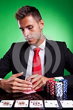 Poker player looking at his cards