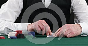 Poker player placing bet after checking hand, all-in, gambling, poker player betting casino chips, believe in success, risky