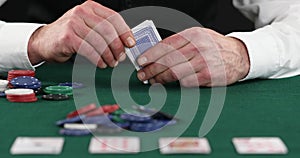 Poker player placing bet after checking hand, all-in, gambling, poker player betting casino chips, believe in success, risky