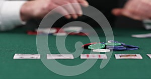 Poker player placing bet after checking hand, all-in, gambling, poker player betting casino chips, believe in success, risky