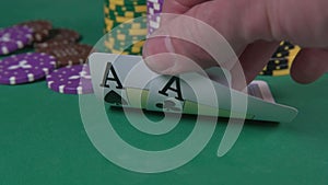 Poker Player with Pocket Aces Considers His Move As Attention Shifts From Cards To Chips