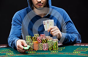 Poker player showing a pair of aces