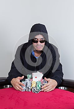 Poker player smiles with pocket aces