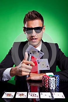 Poker player throwing two ace cards