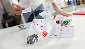 Poker player throws ace cards and casino chips