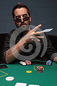 Poker player tossing his cards