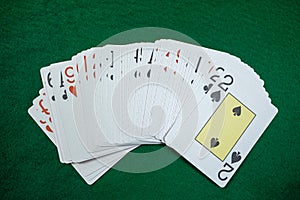 Poker playing cards on a green table background at casino