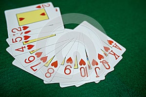 Poker playing cards on a green table background at casino