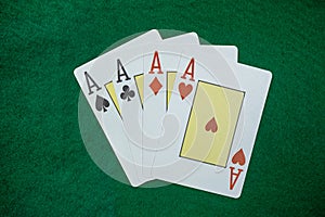 Poker playing cards on a green table background at casino