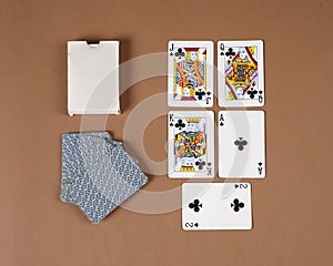 Poker playing cards. Poker set with isolated cards on brown background.