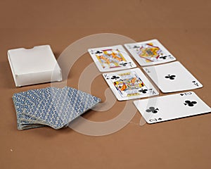 Poker playing cards. Poker set with isolated cards on brown background.