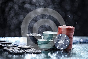 Poker playing chips on a green table and black background. Online gambling. Addiction. Casino play