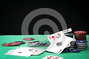 Poker playing chips on a green table and black background. Online gambling. Addiction. Falling poker chips