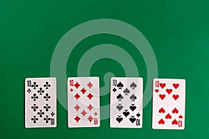 Poker quads playing card, green background photo