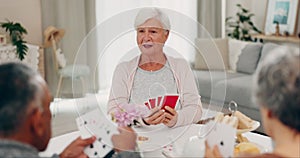Poker, retirement and senior friends at a tea party together during a visit in a home for bonding. Playing cards