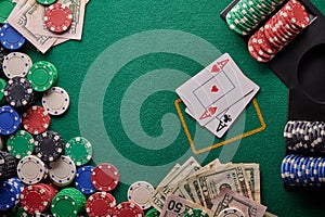 Poker table in a casino with chips and dollars with two aces. With space