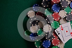 Poker table in a casino with chips with two aces. With space