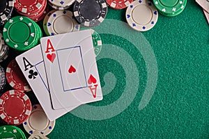 Poker table in a casino with chips with two aces. With space