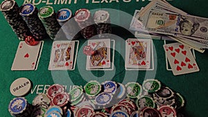 Poker table during a game. Chips, cards and dices on the table in casino