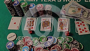 Poker table during a game. Chips, cards and dices on the table in casino