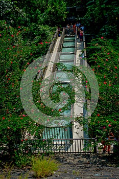 Pokhara, Nepal - September 12, 2017:Above view of unidenfied peoplewalking over the hanging long metal bridge over the