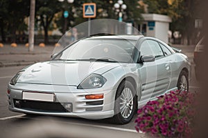 Pokrov, Ukraine - July, 23 2021: Gray Mitsubishi Eclipse sports car coupe stands parked in the city among other cars