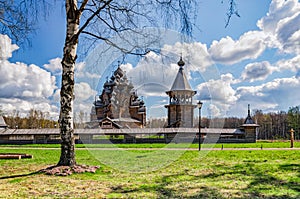 The Pokrovskaya church and the bellfry behind the birch tree at the Easter day.