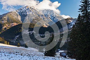 Polana Chocholowska in winter sunny day, Western Tatra Mountains, Poland. The valley and old wooden huts covered in snow