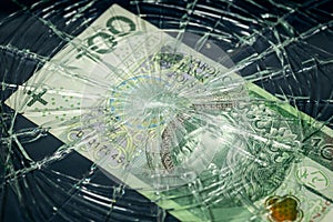 Poland money, Fall of the Polish currency, Weakening of the Polish zloty 100 zloty banknote lying behind the broken window,