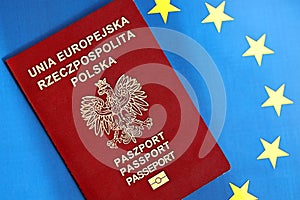 Poland passport of European Union on blue flag background close up. Tourism and citizenship