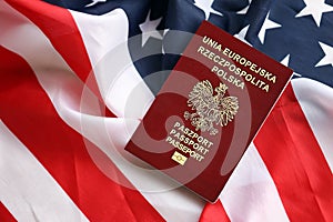 Poland passport on United States national flag background close up. Tourism and diplomacy