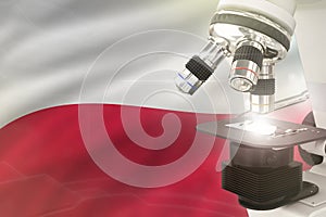Poland science development concept - microscope on flag background. Research in genetics or physics 3D illustration of object
