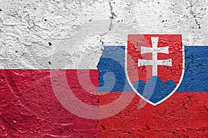 Poland and Slovakia - Cracked concrete wall painted with a Polish flag on the left and a Slovakian flag on the right stock photo