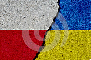 poland and ukraine flags painted over cracked wall