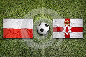 Poland vs. Northern Ireland flags on soccer field