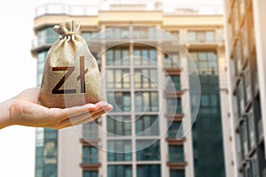 Poland zloty bag against the background of modern high-rise buildings. photo