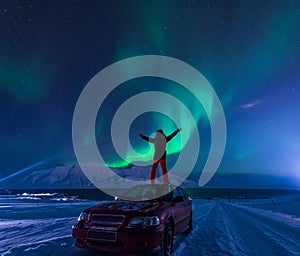 The polar arctic man Northern lights aurora borealis sky star in Norway Svalbard in Longyearbyen city moon mountains