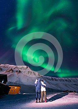 The polar arctic Northern lights aurora borealis sky star Norway Svalbard in Longyearbyen city mountains
