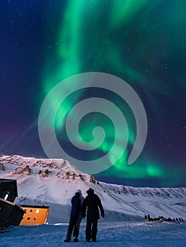 The polar arctic Northern lights aurora borealis sky star Norway Svalbard in Longyearbyen city mountains