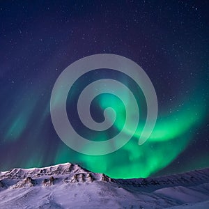 The polar arctic Northern lights aurora borealis sky star in Norway Svalbard Longyearbyen city snowscooter mountains photo