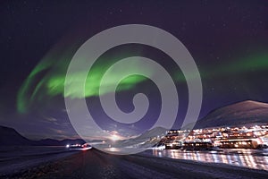 Polar arctic Northern lights aurora borealis sky star in Norway Svalbard in Longyearbyen city travel mountains