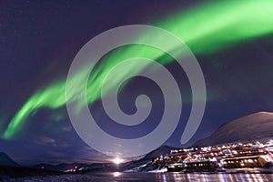 Polar arctic Northern lights aurora borealis sky star in Norway Svalbard in Longyearbyen city travel mountains